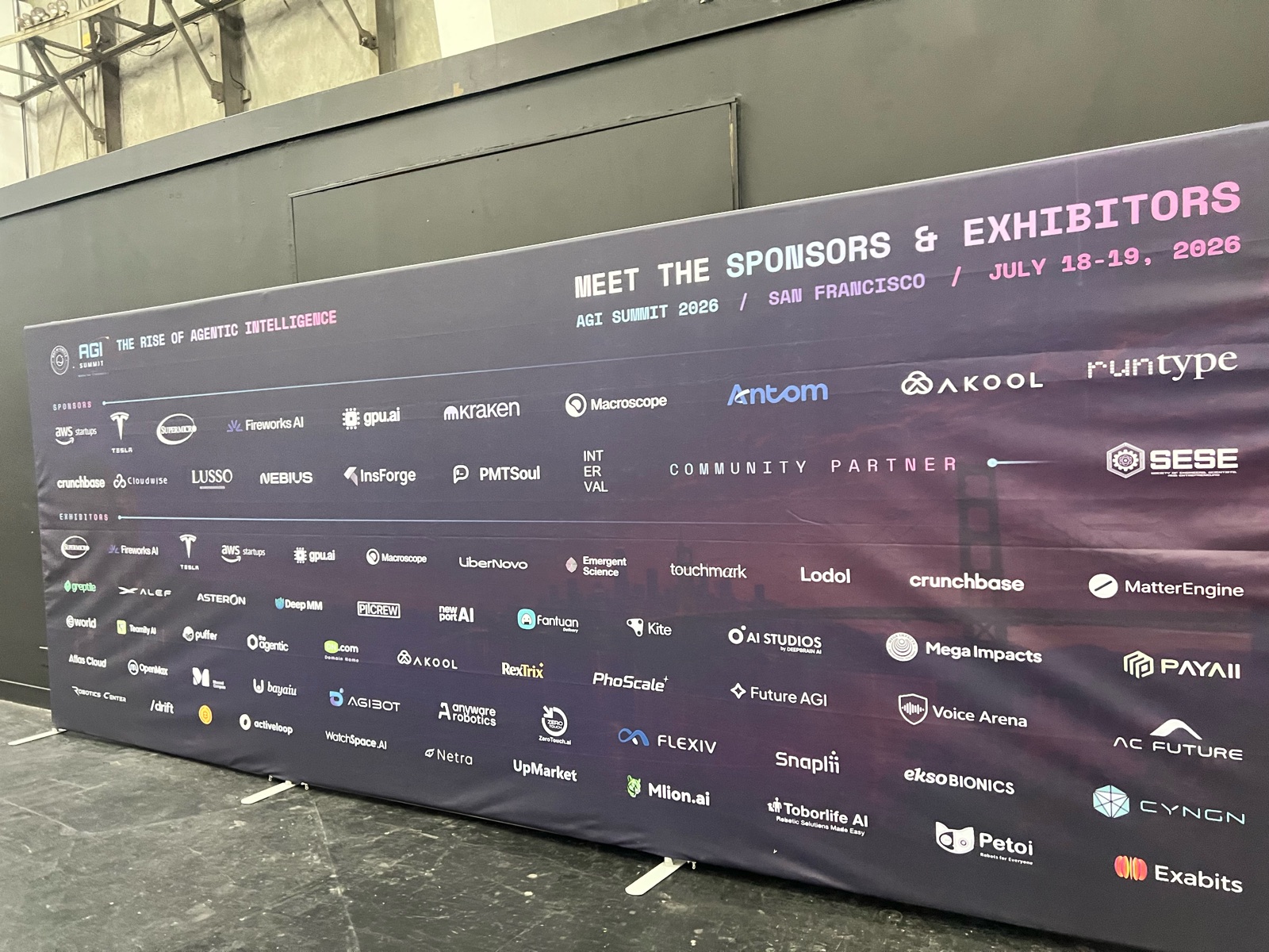 AGI Summit 2026 sponsors and exhibitors wall, San Francisco, July 18–19 2026, with PhoScale listed among the exhibitors